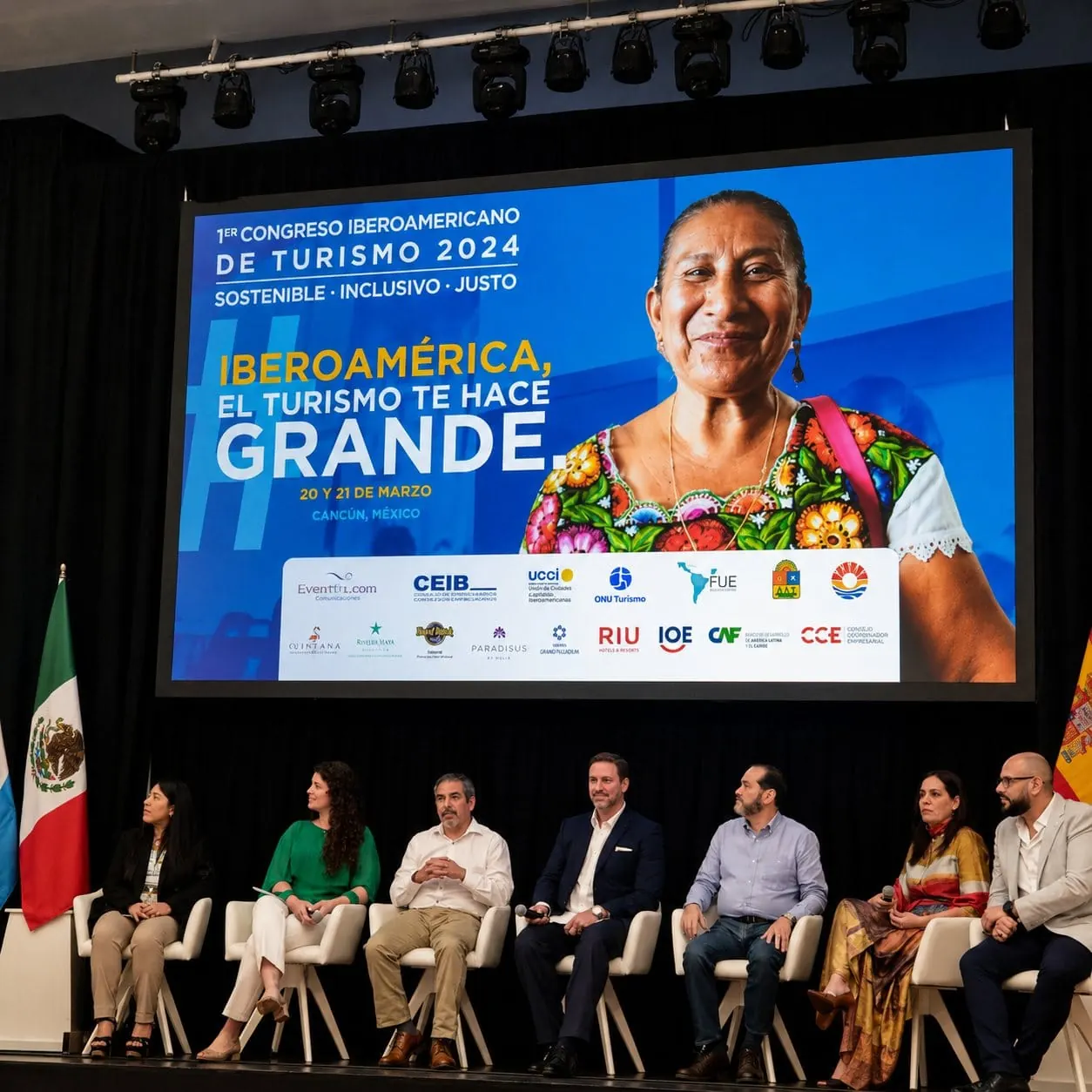 Panel of seven speakers beneath a screen announcing the 1st Ibero-American Tourism Congress 2024, sustainable, inclusive and fair, Cancún