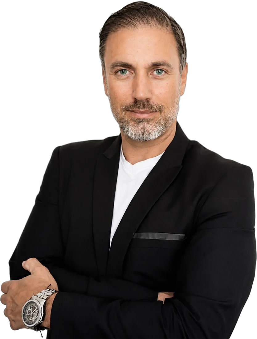 Portrait of Héctor De Castro in a black jacket and white shirt, arms folded
